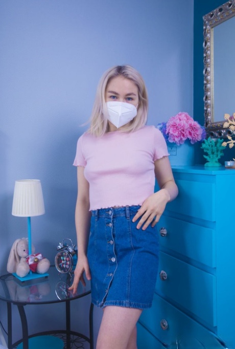 Young blonde Kira Stone removes a covid mask and clothes on her bed 88548897